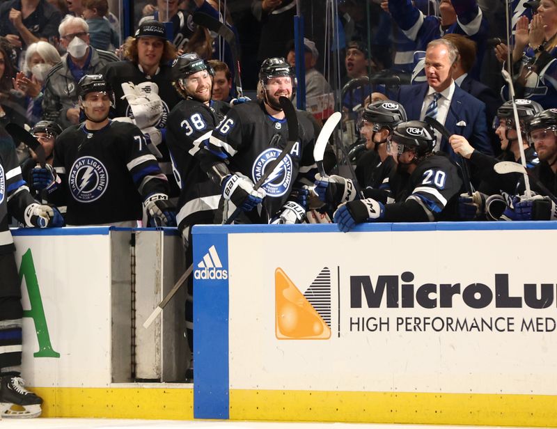 Apr 17, 2024; Tampa, Florida, USA; Tampa Bay Lightning right wing Nikita Kucherov (86) is congratulated by left wing Brandon Hagel (38) after his 100th assist of the year on a goal by center Brayden Point (21) during the second period at Amalie Arena. Mandatory Credit: Kim Klement Neitzel-USA TODAY Sports