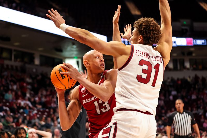 Feb 4, 2023; Columbia, South Carolina, USA; Arkansas Razorbacks guard Jordan Walsh (13) looks to pass around South Carolina Gamecocks forward Benjamin Bosmans-Verdonk (31) in the first half at Colonial Life Arena. Mandatory Credit: Jeff Blake-USA TODAY Sports