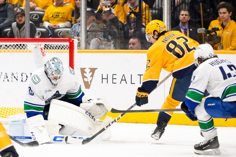 Jan 29, 2025; Nashville, Tennessee, USA;  Vancouver Canucks goaltender Thatcher Demko (35) blocks the shot of Nashville Predators center Tommy Novak (82) during the third period at Bridgestone Arena. Mandatory Credit: Steve Roberts-Imagn Images