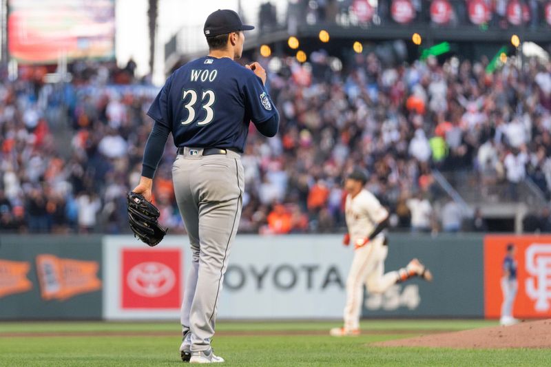 Jul 3, 2023; San Francisco, California, USA;  Seattle Mariners starting pitcher Bryan Woo (33) reacts as San Francisco Giants catcher Blake Sabol (2) runs the bases after hitting a two run home run during the fourth inning at Oracle Park. Mandatory Credit: Stan Szeto-USA TODAY Sports