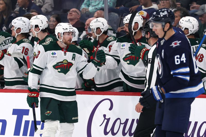 Sep 21, 2025; Winnipeg, Manitoba, CAN; Minnesota Wild center Yakov Trenin (13) celebrates a goal against the Winnipeg Jets during the second period at Canada Life Centre. Mandatory Credit: James Carey Lauder-Imagn Images