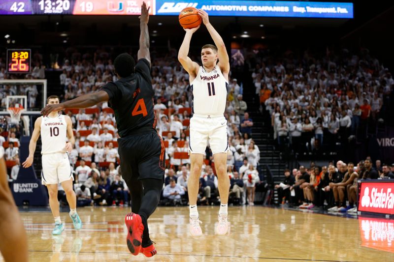 Feb 5, 2024; Charlottesville, Virginia, USA; Virginia Cavaliers guard Isaac McKneely (11) shoots the ball over Miami (Fl) Hurricanes guard Bensley Joseph (4) during the second half at John Paul Jones Arena. Mandatory Credit: Amber Searls-USA TODAY Sports