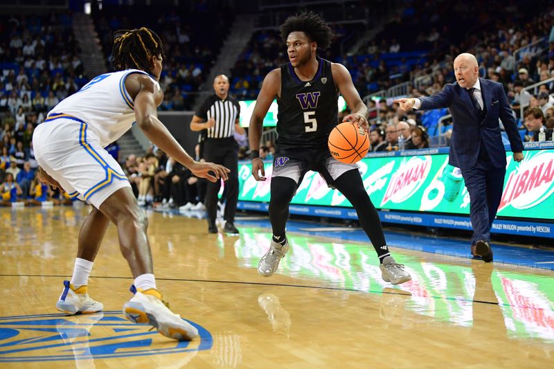 January 14, 2024; Los Angeles, California, USA; Washington Huskies guard Sahvir Wheeler (5) moves the ball against UCLA Bruins guard Dylan Andrews (2) during the first half at Pauley Pavilion. Mandatory Credit: Gary A. Vasquez-USA TODAY Sports