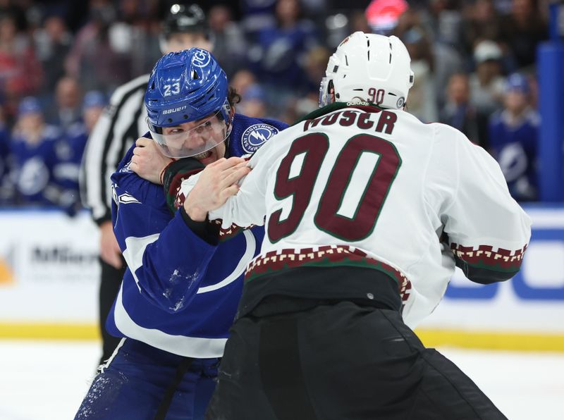 Jan 25, 2024; Tampa, Florida, USA; Tampa Bay Lightning center Michael Eyssimont (23) and Arizona Coyotes defenseman J.J. Moser (90) fight during the first period at Amalie Arena. Mandatory Credit: Kim Klement Neitzel-USA TODAY Sports