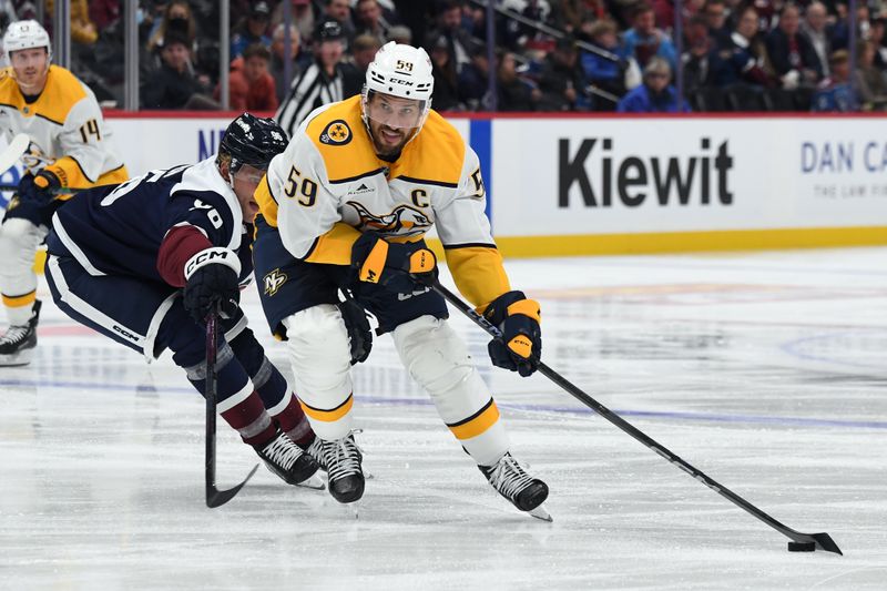 Nov 11, 2024; Denver, Colorado, USA; Nashville Predators defenseman Roman Josi (59) skates with the puck past Colorado Avalanche right wing Mikko Rantanen (96) during the third period at Ball Arena. Mandatory Credit: Christopher Hanewinckel-Imagn Images