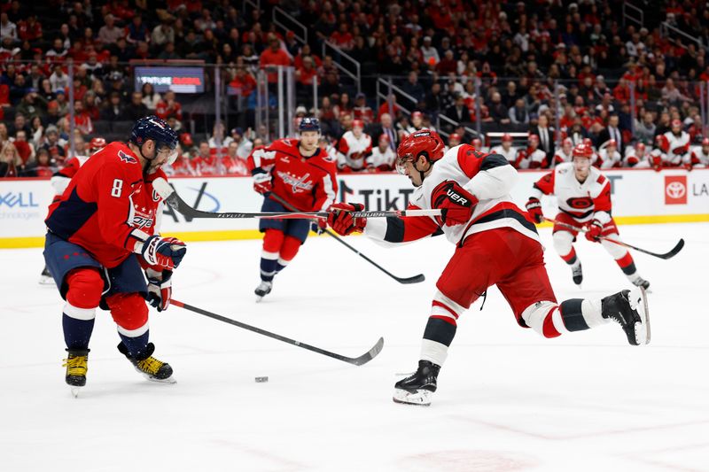 Dec 11, 2025; Washington, District of Columbia, USA; Washington Capitals left wing Alex Ovechkin (8) blocks a shot attempt by Carolina Hurricanes center Sebastian Aho (20) in overtime at Capital One Arena. Mandatory Credit: Geoff Burke-Imagn Images