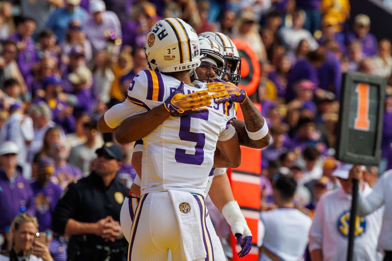 Nov 25, 2023; Baton Rouge, Louisiana, USA;  LSU Tigers wide receiver Malik Nabers (8) hugs quarterback Jayden Daniels (5) after scoring a touchdown against the Texas A&M Aggies during the first half at Tiger Stadium. Mandatory Credit: Stephen Lew-USA TODAY Sports