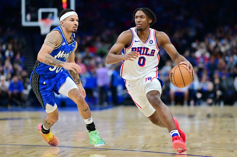 ORLANDO, FLORIDA - JANUARY 19: Tyrese Maxey #0 of the Philadelphia 76ers drives to the basket against Cole Anthony #50 of the Orlando Magic in the first half of a game at Kia Center on January 19, 2024 in Orlando, Florida. NOTE TO USER: User expressly acknowledges and agrees that, by downloading and or using this photograph, User is consenting to the terms and conditions of the Getty Images License Agreement. (Photo by Julio Aguilar/Getty Images)