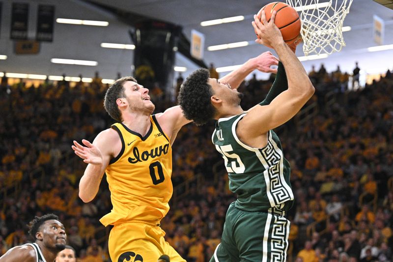 Feb 25, 2023; Iowa City, Iowa, USA; Iowa Hawkeyes forward Filip Rebraca (0) defends the shot of Michigan State Spartans forward Malik Hall (25) during the second half at Carver-Hawkeye Arena. Mandatory Credit: Jeffrey Becker-USA TODAY Sports