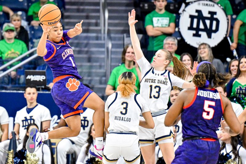 Feb 22, 2024; South Bend, Indiana, USA; Clemson Tigers guard Dayshanette Harris (1) passes the ball as Notre Dame Fighting Irish guard Hannah Hidalgo (3) and guard Anna Dewolfe (13) defend in the second half at the Purcell Pavilion. Mandatory Credit: Matt Cashore-USA TODAY Sports