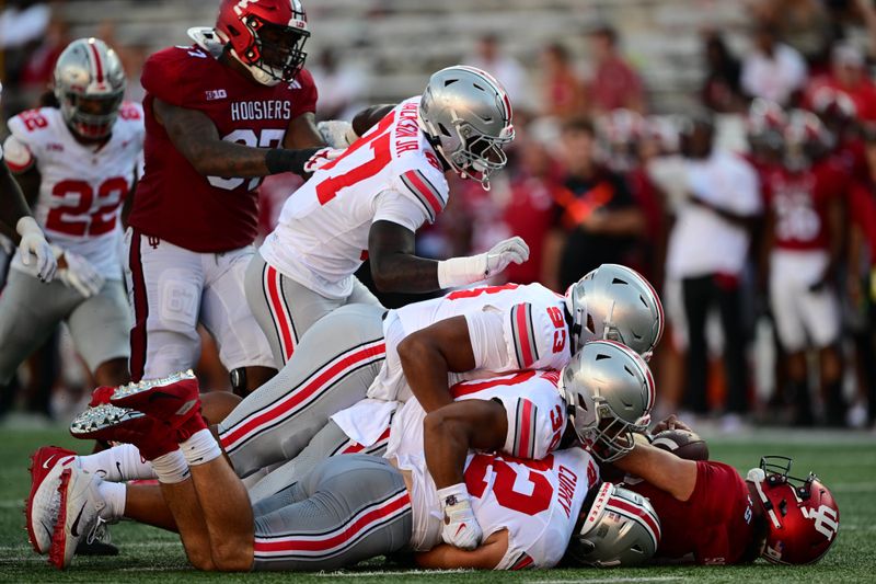 Sep 2, 2023; Bloomington, Indiana, USA; Indiana Hoosiers quarterback Brendan Sorsby (15) is sacked by four Ohio State Buckeyes during the second half at Memorial Stadium. Mandatory Credit: Marc Lebryk-USA TODAY Sports