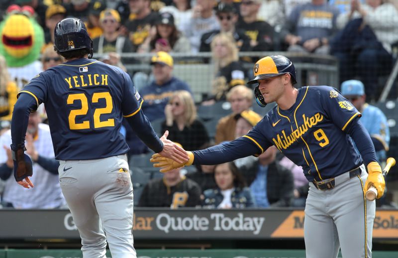 May 24, 2025; Pittsburgh, Pennsylvania, USA;  Milwaukee Brewers left fielder Jake Bauers (9) greets designated hitter Christian Yelich (22) crossing home plate to score a run against the Pittsburgh Pirates during the second inning at PNC Park. Mandatory Credit: Charles LeClaire-Imagn Images
