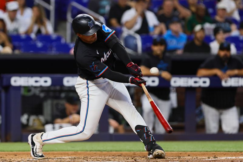 Apr 26, 2024; Miami, Florida, USA; Miami Marlins catcher Nick Fortes (4) hits an RBI single against the Washington Nationals during the third inning at loanDepot Park. Mandatory Credit: Sam Navarro-USA TODAY Sports