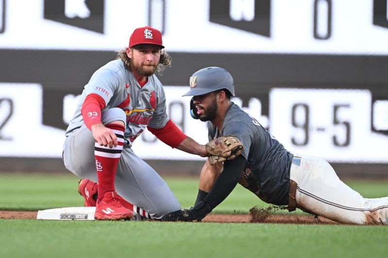 Jul 5, 2024; Washington, District of Columbia, USA; St. Louis Cardinals left fielder Brendan Donovan (33) tags out Washington Nationals second baseman Luis Garcia Jr. (2) ay second base during the first inning at Nationals Park. Mandatory Credit: Rafael Suanes-USA TODAY Sports