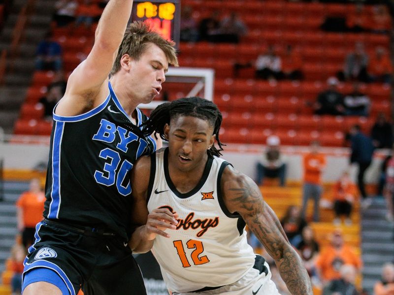 Feb 17, 2024; Stillwater, Oklahoma, USA; Oklahoma State Cowboys guard Javon Small (12) drives around Brigham Young Cougars guard Dallin Hall (30) during the first half at Gallagher-Iba Arena. Mandatory Credit: William Purnell-USA TODAY Sports