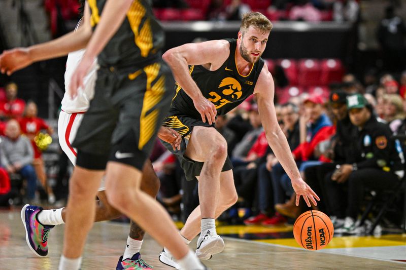 Feb 14, 2024; College Park, Maryland, USA; Iowa Hawkeyes forward Ben Krikke (23) dribbles up the court during the first half against the Maryland Terrapins  at Xfinity Center. Mandatory Credit: Tommy Gilligan-USA TODAY Sports