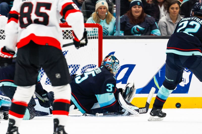 Jan 4, 2024; Seattle, Washington, USA; Seattle Kraken goaltender Joey Daccord (35) blocks a shot against the Ottawa Senators during the second period at Climate Pledge Arena. Mandatory Credit: Joe Nicholson-USA TODAY Sports