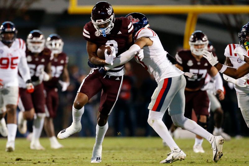 Nov 23, 2023; Starkville, Mississippi, USA; Mississippi State Bulldogs wide receiver Justin Robinson (3) runs after a catch as Mississippi Rebels defensive back Daijahn Anthony (3) makes the tackle during the first half at Davis Wade Stadium at Scott Field. Mandatory Credit: Petre Thomas-USA TODAY Sports