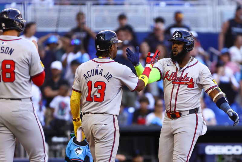 Apr 14, 2024; Miami, Florida, USA; Atlanta Braves designated hitter Marcell Ozuna (20) celebrates with right fielder Ronald Acuna Jr. (13) after hitting a two-run home run against the Miami Marlins during the ninth inning at loanDepot Park. Mandatory Credit: Sam Navarro-USA TODAY Sports