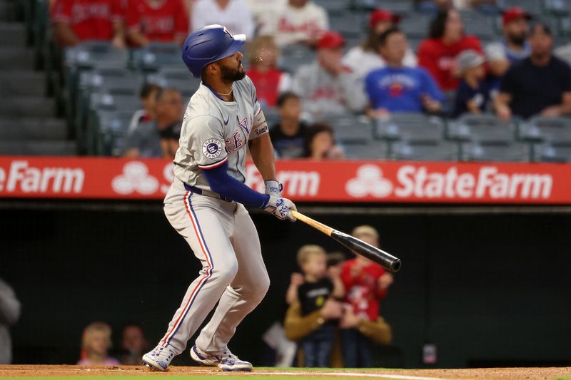 Sep 28, 2024; Anaheim, California, USA;  Texas Rangers second baseman Marcus Semien (2) hits a double during the first inning against the Los Angeles Angels at Angel Stadium. Mandatory Credit: Kiyoshi Mio-Imagn Images