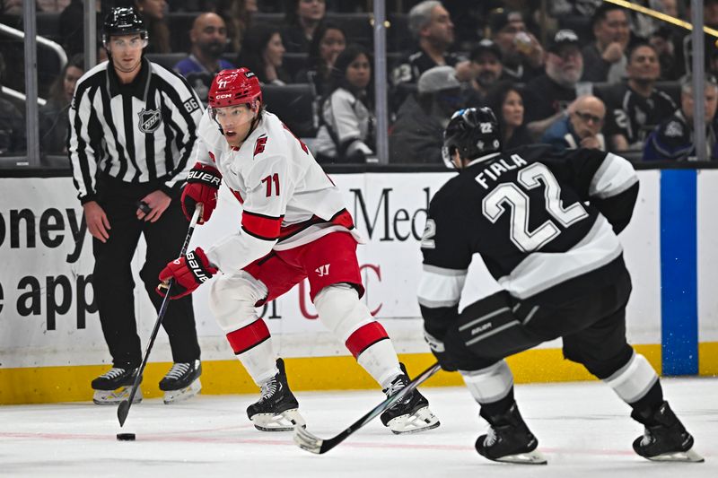 Mar 22, 2025; Los Angeles, California, USA; Carolina Hurricanes left wing Taylor Hall (71) moves the puck against Los Angeles Kings left wing Kevin Fiala (22) during the first period at Crypto.com Arena. Mandatory Credit: Jonathan Hui-Imagn Images