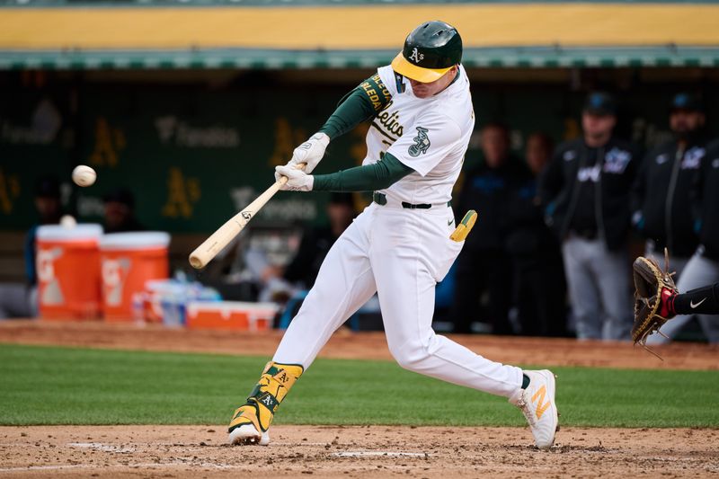 May 4, 2024; Oakland, California, USA; Oakland Athletics outfielder JJ Bleday (33) hits a three-run home run against the Miami Marlins during the third inning at Oakland-Alameda County Coliseum. Mandatory Credit: Robert Edwards-USA TODAY Sports