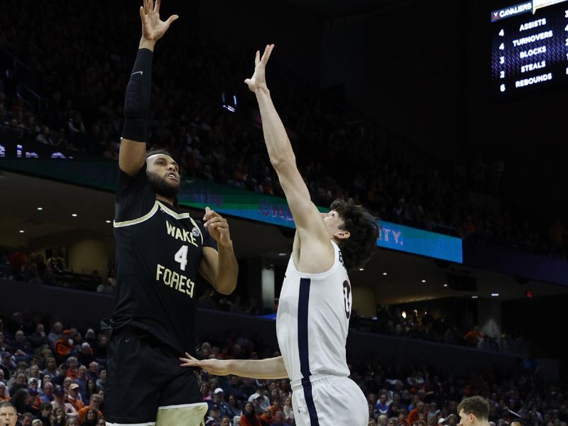 Feb 17, 2024; Charlottesville, Virginia, USA; Wake Forest Demon Deacons forward Efton Reid III (4) shoots the ball as Virginia Cavaliers forward Blake Buchanan (0) defends in the first half at John Paul Jones Arena. Mandatory Credit: Geoff Burke-USA TODAY Sports