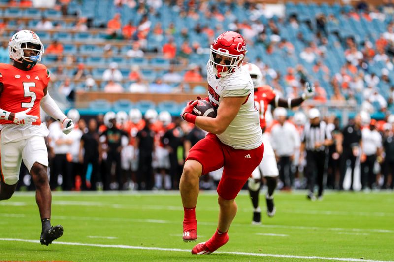 Nov 18, 2023; Miami Gardens, Florida, USA; Louisville Cardinals tight end Nate Kurisky (85) scores a touchdown against the Miami Hurricanes during the first quarter at Hard Rock Stadium. Mandatory Credit: Sam Navarro-USA TODAY Sports