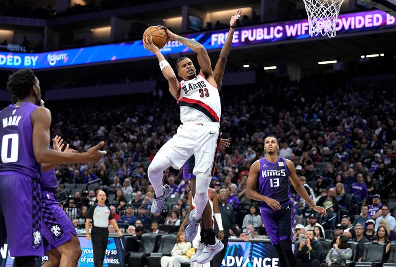 SACRAMENTO, CALIFORNIA - OCTOBER 28: Toumani Camara #33 of the Portland Trail Blazers goes up to shoot over De'Aaron Fox #5 of the Sacramento Kings during the fourth quarter at Golden 1 Center on October 28, 2024 in Sacramento, California. NOTE TO USER: User expressly acknowledges and agrees that, by downloading and or using this photograph, User is consenting to the terms and conditions of the Getty Images License Agreement. (Photo by Thearon W. Henderson/Getty Images)