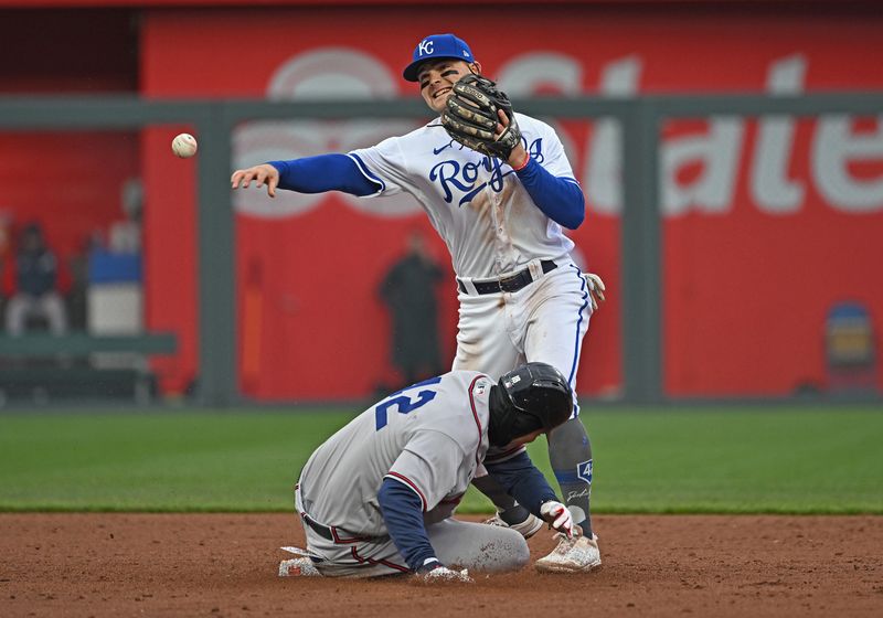 Apr 15, 2023; Kansas City, Missouri, USA;  Kansas City Royals second baseman Michael Massey (19) throws to first base over Atlanta Braves player Vaughn Grissom (15) during the third inning at Kauffman Stadium. Mandatory Credit: Peter Aiken-USA TODAY Sports