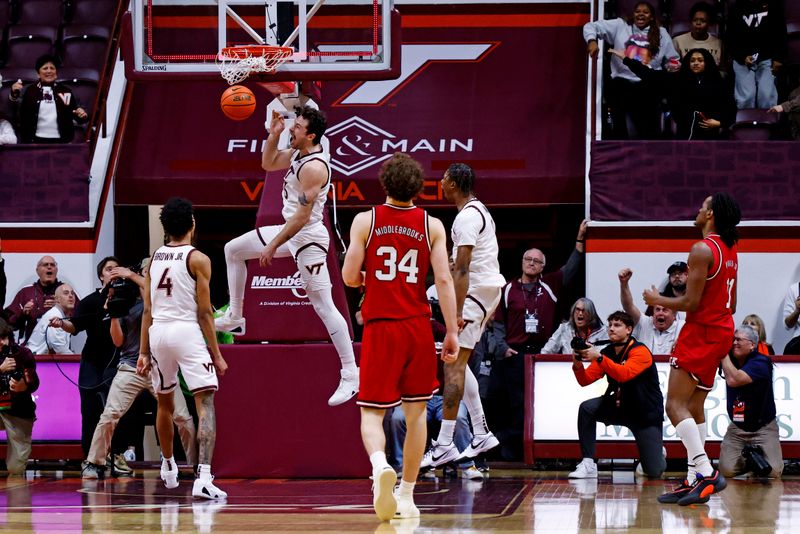 Jan 15, 2025; Blacksburg, Virginia, USA; Virginia Tech Hokies forward Ben Burnham (13) dunks the ball with no time left to beat the North Carolina State Wolfpack at Cassell Coliseum. Mandatory Credit: Peter Casey-Imagn Images