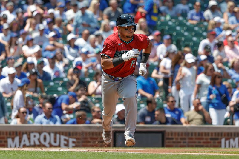 Jul 19, 2024; Chicago, Illinois, USA; Arizona Diamondbacks catcher Gabriel Moreno (14) runs to first base after hitting a single against the Chicago Cubs during the first inning at Wrigley Field. Mandatory Credit: Kamil Krzaczynski-USA TODAY Sports