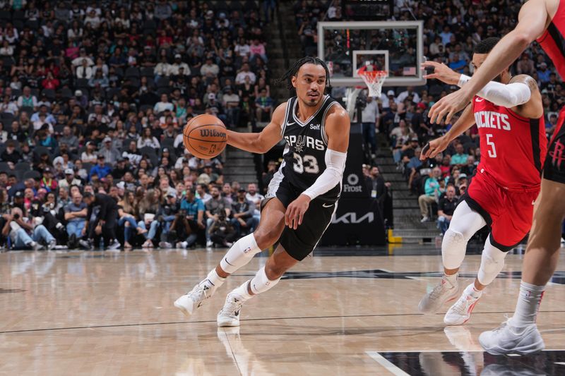 SAN ANTONIO, TX - MARCH 12: Tre Jones #33 of the San Antonio Spurs dribbles the ball during the game against the Houston Rockets on March 12, 2024 at the Frost Bank Center in San Antonio, Texas. NOTE TO USER: User expressly acknowledges and agrees that, by downloading and or using this photograph, user is consenting to the terms and conditions of the Getty Images License Agreement. Mandatory Copyright Notice: Copyright 2024 NBAE (Photos by Jesse D. Garrabrant/NBAE via Getty Images)