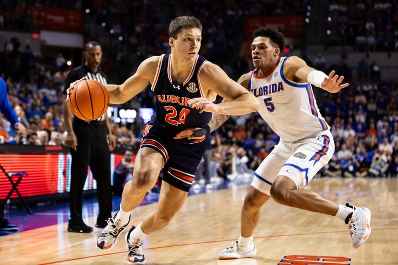 Feb 10, 2024; Gainesville, Florida, USA; Auburn Tigers guard Lior Berman (24) drives to the basket against Florida Gators guard Will Richard (5) during the first half at Exactech Arena at the Stephen C. O'Connell Center. Mandatory Credit: Matt Pendleton-USA TODAY Sports