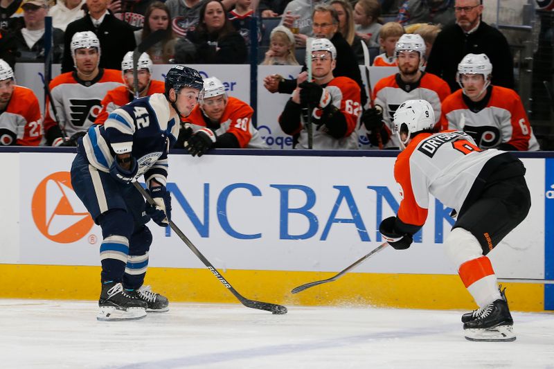 Apr 6, 2024; Columbus, Ohio, USA; Columbus Blue Jackets center Alexander Texier (42) carries the puck as Philadelphia Flyers defenseman Jamie Drysdale (9) defends during the first period at Nationwide Arena. Mandatory Credit: Russell LaBounty-USA TODAY Sports