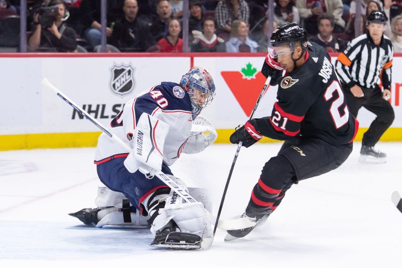 Feb 13, 2024; Ottawa, Ontario, CAN; Columbus Blue Jackets goalie Daniil Tarasov (40) makes a save on a shot from Ottawa Senators right wing Mathieu Joseph (21) in the first period at the Canadian Tire Centre. Mandatory Credit: Marc DesRosiers-USA TODAY Sports