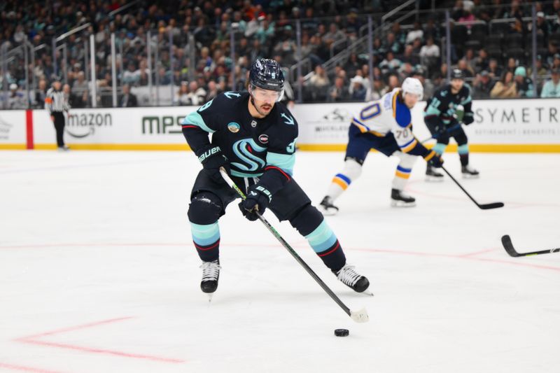 Apr 12, 2025; Seattle, Washington, USA; Seattle Kraken center Chandler Stephenson (9) advances the puck against the St. Louis Blues during the second period at Climate Pledge Arena. Mandatory Credit: Steven Bisig-Imagn Images