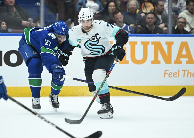 Apr 2, 2025; Vancouver, British Columbia, CAN; Vancouver Canucks defenseman Derek Forbort (27) checks Seattle Kraken forward Jordan Eberle (7) during the first period at Rogers Arena. Mandatory Credit: Simon Fearn-Imagn Images