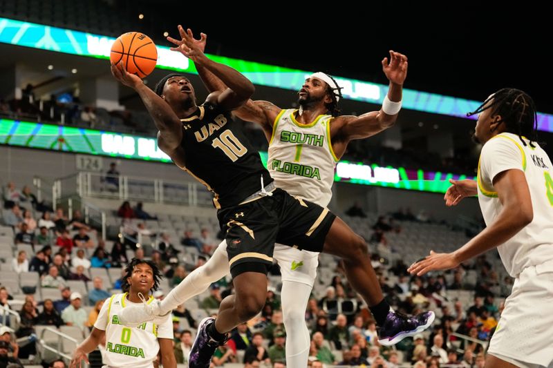 Mar 16, 2024; Fort Worth, TX, USA;  UAB Blazers guard Alejandro Vasquez (10) is fouled by South Florida Bulls guard Selton Miguel (1) while shooting during the second half at Dickies Arena. Mandatory Credit: Chris Jones-USA TODAY Sports