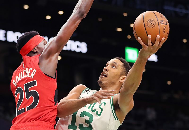 Boston, MA - October 5: Boston Celtics PG Malcolm Brogdon makes a 1st quarter layup over Toronto Raptors PF Chris Boucher. The Celtics lost to the Raptors, 125-119. (Photo by John Tlumacki/The Boston Globe via Getty Images)