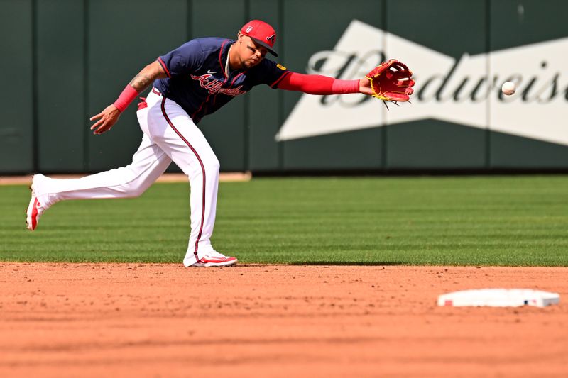 Mar 5, 2024; North Port, Florida, USA;  Atlanta Braves shortstop Orlando Arcia (11) reaches for a ground ball in the third inning of the spring training game against the Detroit Tigers  at CoolToday Park. Mandatory Credit: Jonathan Dyer-USA TODAY Sports