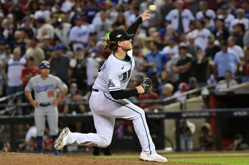 Oct 11, 2023; Phoenix, Arizona, USA; Arizona Diamondbacks relief pitcher Andrew Saalfrank (57) throws a pitch against the Los Angeles Dodgers in the seventh inning for game three of the NLDS for the 2023 MLB playoffs at Chase Field. Mandatory Credit: Matt Kartozian-USA TODAY Sports