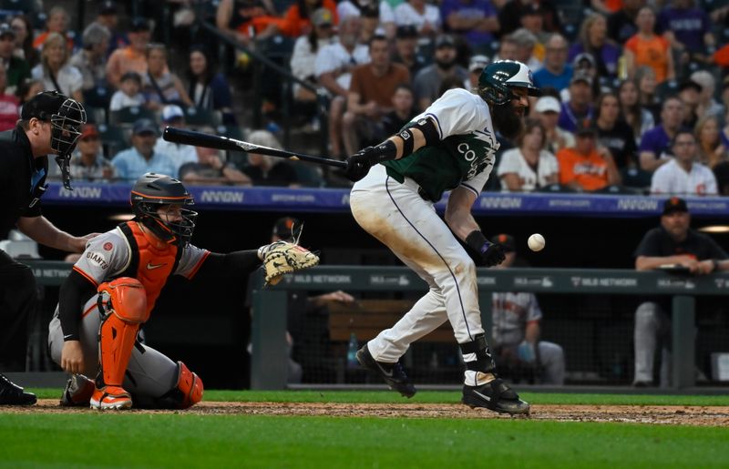 Jul 20, 2024; Denver, Colorado, USA;  Colorado Rockies designated hitter Charlie Blackmon (19) fouls the ball off his body in the seventh inning against the San Francisco Giants at Coors Field. Mandatory Credit: John Leyba-USA TODAY Sports