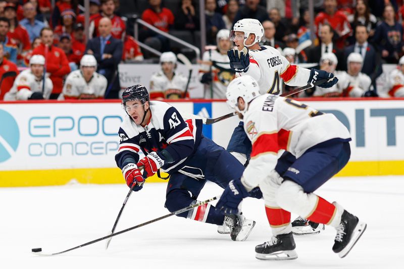 Nov 8, 2023; Washington, District of Columbia, USA; Washington Capitals right wing Tom Wilson (43) attempts to pass the puck as Florida Panthers defenseman Gustav Forsling (42) and Panthers defenseman Oliver Ekman-Larsson (91) defend in the third period at Capital One Arena. Mandatory Credit: Geoff Burke-USA TODAY Sports