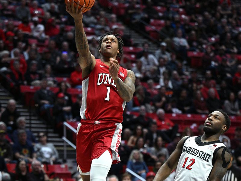 Feb 11, 2023; San Diego, California, USA; UNLV Rebels guard Elijah Parquet (1) goes to the basket past San Diego State Aztecs guard Darrion Trammell (12) during the second half at Viejas Arena. Mandatory Credit: Orlando Ramirez-USA TODAY Sports