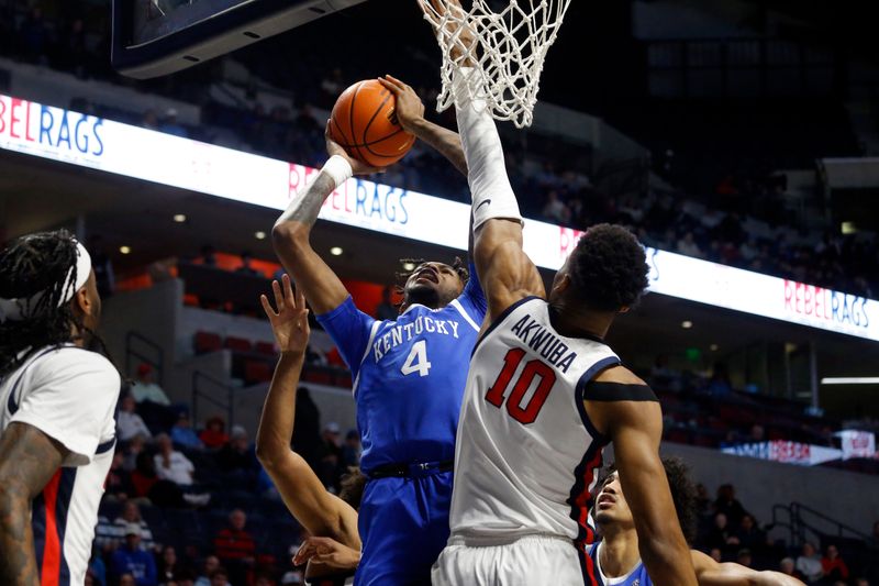 Jan 31, 2023; Oxford, Mississippi, USA; Kentucky Wildcats forward Daimion Collins (4) shoots as Mississippi Rebels forward Theo Akwuba (10) defends during the first half at The Sandy and John Black Pavilion at Ole Miss. Mandatory Credit: Petre Thomas-USA TODAY Sports