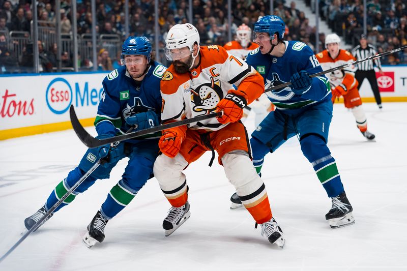 Mar 24, 2026; Vancouver, British Columbia, CAN; Vancouver Canucks forward Linus Karlsson (94) and forward Drew O'Connor (18) battle with Anaheim Ducks defenseman Radko Gudas (7) in the second period at Rogers Arena. Mandatory Credit: Bob Frid-Imagn Images
