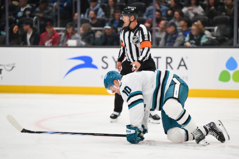 Nov 30, 2024; Seattle, Washington, USA; San Jose Sharks center Klim Kostin (10) is slow to get up after an injury during the second against the Seattle Kraken period at Climate Pledge Arena. Mandatory Credit: Steven Bisig-Imagn Images