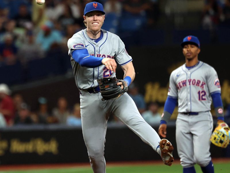 May 3, 2024; St. Petersburg, Florida, USA;  New York Mets third base Brett Baty (22) throws the ball to first base against the Tampa Bay Rays during the second inning at Tropicana Field. Mandatory Credit: Kim Klement Neitzel-USA TODAY Sports