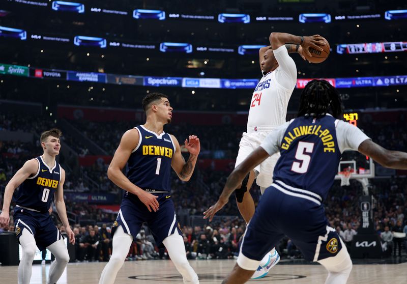 LOS ANGELES, CALIFORNIA - APRIL 04: Norman Powell #24 of the LA Clippers looks to pass in front of Kentavious Caldwell-Pope #5 Michael Porter Jr. #1 and Christian Braun #0 of the Denver Nuggets during the first half at Crypto.com Arena on April 04, 2024 in Los Angeles, California. User is consenting to the terms and conditions of the Getty Images License Agreement. (Photo by Harry How/Getty Images)